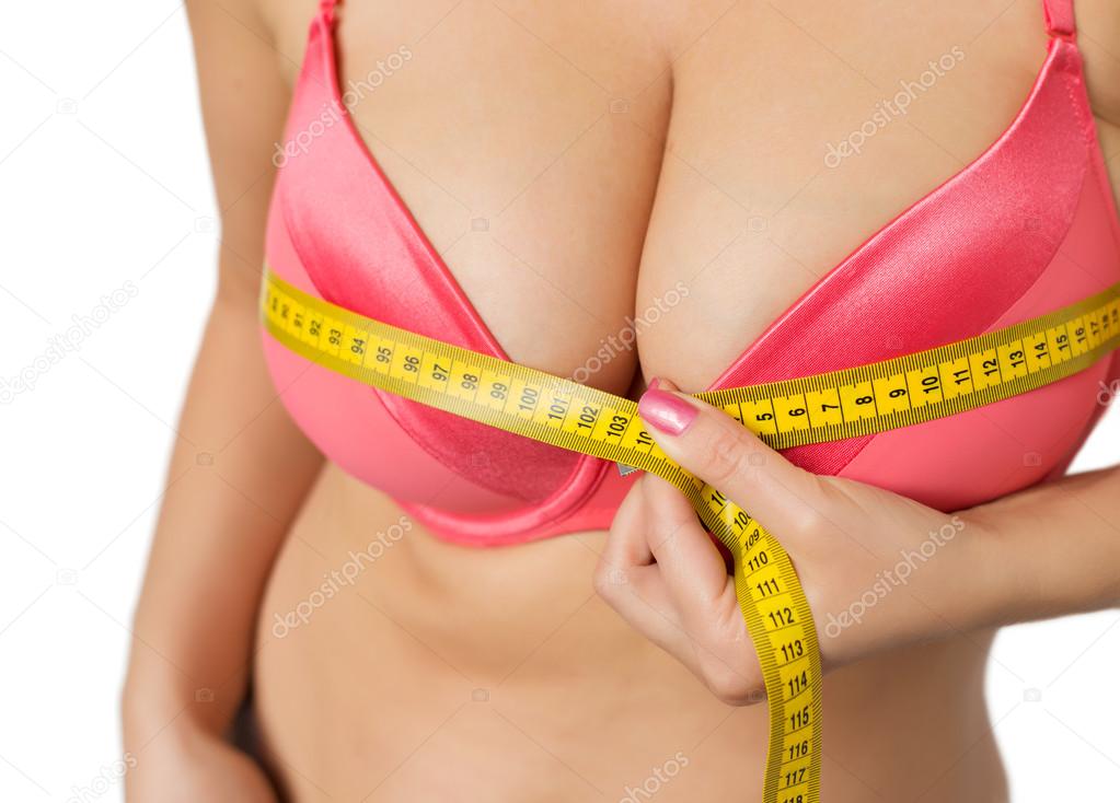 Woman with big breasts measuring her bust