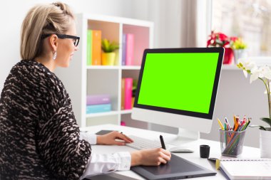Designer using graphics tablet while working with computer clipart
