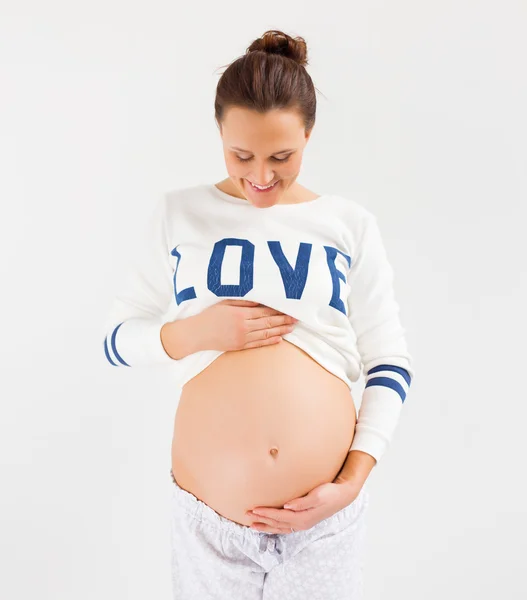 Pregnant woman holding her belly — Stock Photo, Image