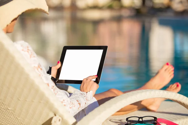 Жінка використовує планшетний комп'ютер біля басейну — стокове фото
