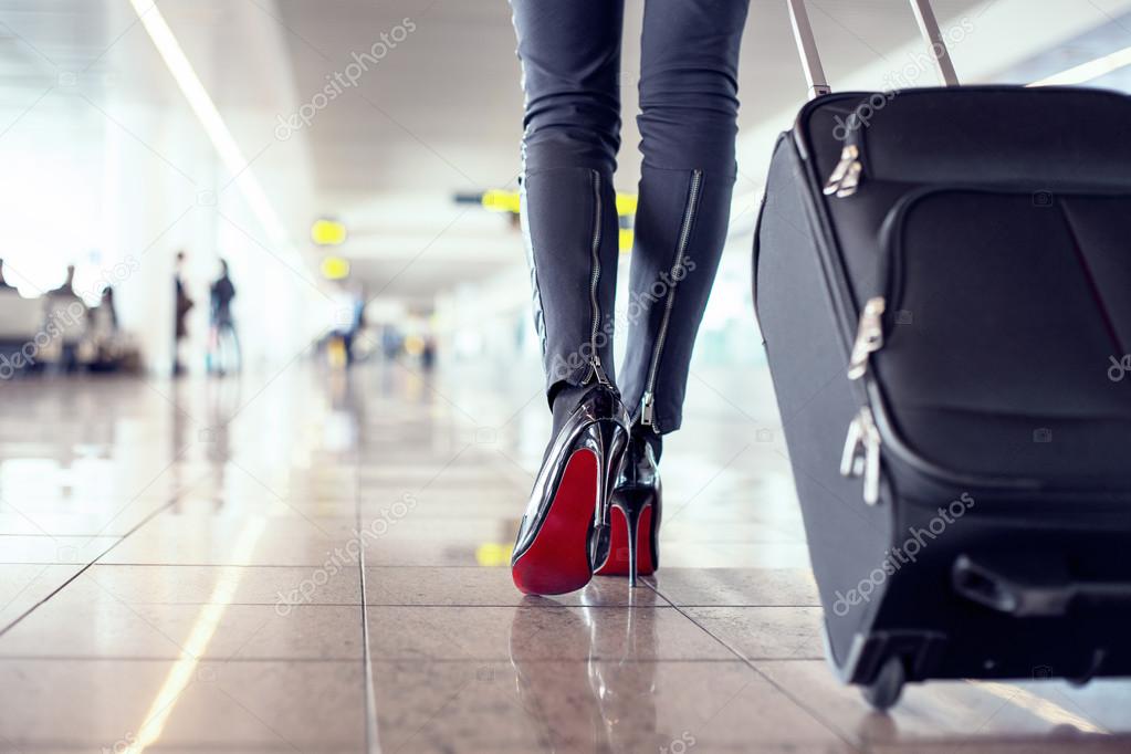 Woman walking through airport with luggage