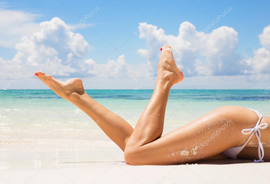 Sexy women legs on the beach