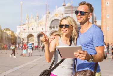 Tourists using tablet computer while traveling