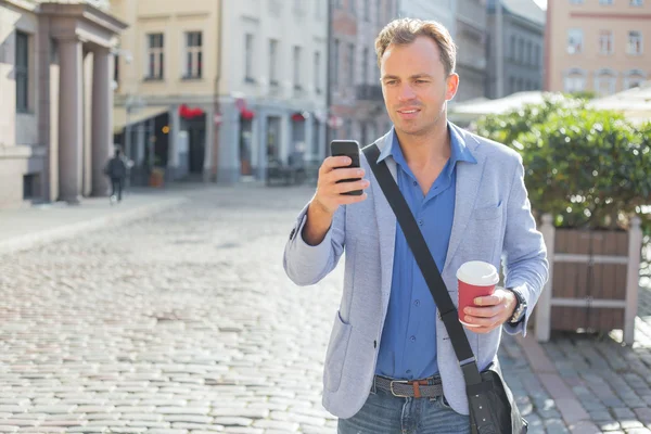 Man with coffee outdoors — Stock Photo, Image