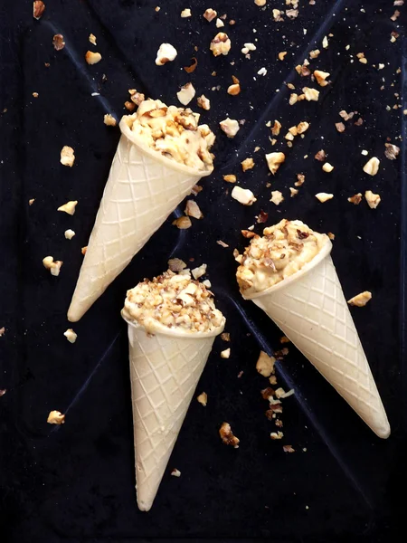 caramel ice cream cone topped with caramelized walnuts