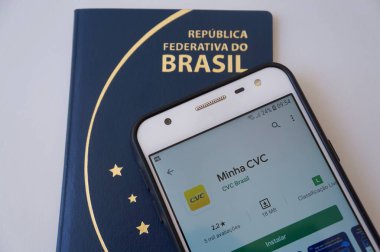 Bahia, Brezilya. 9 Nisan 2020. Brezilya pasaportunun üstündeki akıllı telefon ekranında Minha CVC uygulaması. CVC Brezilyalı bir seyahat acentesi, Brezilya 'nın en büyük tur operatörü. Turizm konsepti.