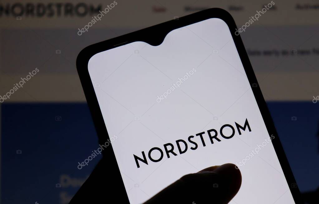 Bahia, Brazil - June 8, 2021: Hand holding smartphone with Nordstrom logo on screen. Nordstrom is a leading fashion retailer based in the U.S.