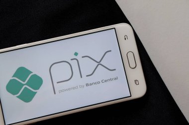 Bahia, Brazil - October 9, 2020. Pix logo on smartphone screen on office desk. Pix is the new instant payment system from Central Bank of Brazil (Banco Central do Brasil).