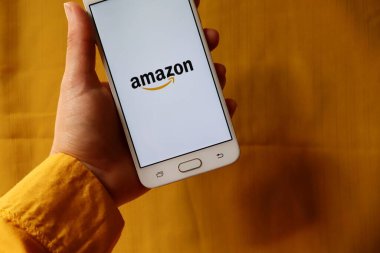 Bahia, Brazil - September 23, 2020. Amazon App on yellow background. Amazon is an American Multinational technology company.