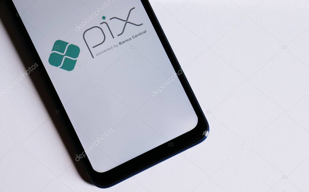Bahia, Brazil - October 6, 2020. Pix logo on smartphone screen on white background. Pix is the new instant payment system from Central Bank of Brazil (Banco Central do Brasil).