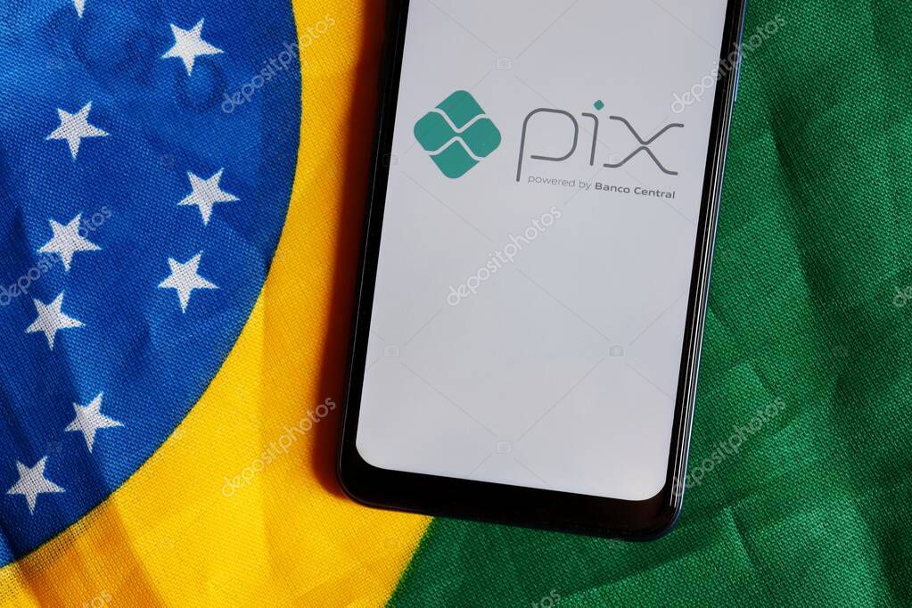 Bahia, Brazil - October 6, 2020. Pix Brazil logo on smartphone screen on top of Brazilian flag. Pix is the new instant payment system from Central Bank of Brazil (Banco Central do Brasil).