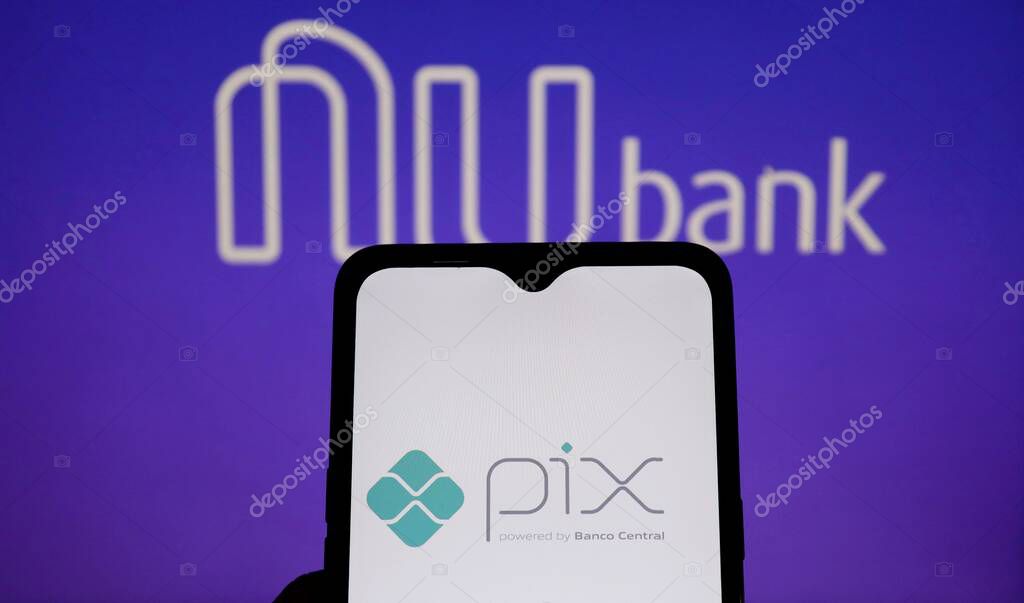 Bahia, Brazil - March 26, 2021: Pix logo on smartphone screen with Nubank logo displayed in the background. Pix is a Brazilian instant payment system.