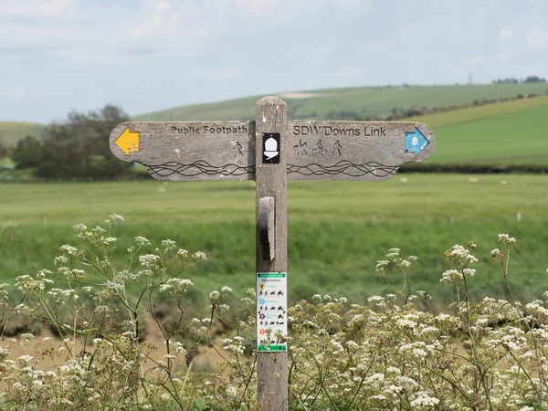 A wooden signpost indicates the route for the South Downs Way in West Sussex .Cycle and foot path,Bridleway