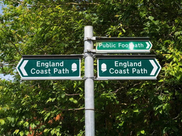 A signpost indicates the England Coast Path with arrows to left and right.Signpost.Footpath
