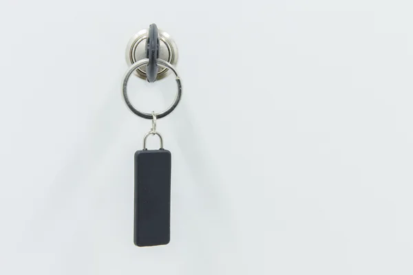 Open locker with keys, key in keyhole — Stock Photo, Image