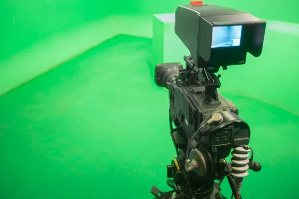 Television studio with camera and lights - camera on green screen — Stock Photo, Image