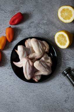 Gri arka planda çiğ tavuk kanadı eti