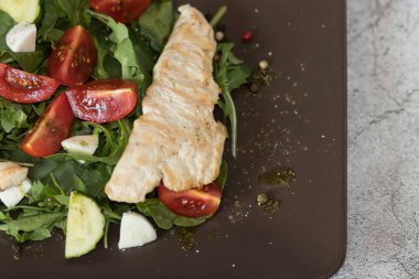 Ispanak yapraklı salata, roka, kiraz domatesleri, mozzarella ve et parçaları. Diyet yemek. Ev yapımı..