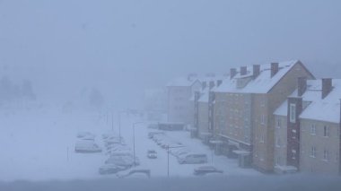 Pencereden dışarıda kar yağdığını görebiliyorsun. kış