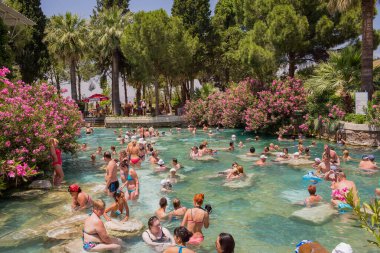 İnsanlar Rodos adasındaki Kleopatra havuzunda yüzüyor..