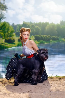Beautiful girl with a Scottish Terrier in the Park clipart