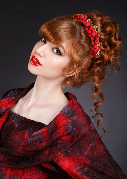 Sexy beautiful redhead girl with long curly hair and a red dress.hair ornament.red lips. — Stock Photo, Image