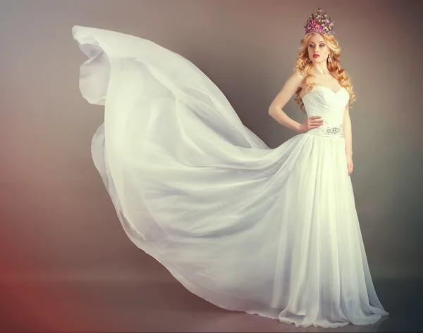 Bride in flying wedding dress in the studio — Stock Photo, Image