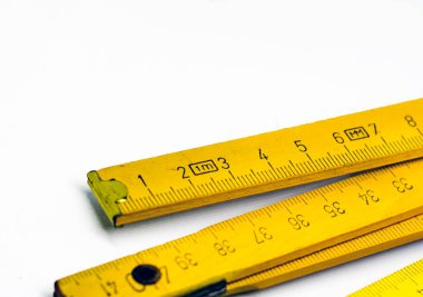 Detail of a folding wooden meter. Measuring tool for construction and renovation works. Graduated scale in centimeters. clipart