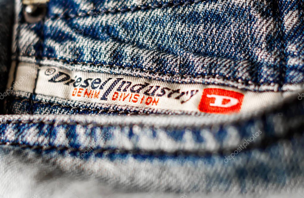 Rome, Italy, April 2021: Detail of the Diesel Industry logo sewn on the front pocket of a pair of jeans trousers. Diesel is an Italian fashion multinational that produces various clothing items