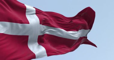 Açık bir günde Danimarka ulusal bayrağının yakın çekimi. Bayrağın kenarına uzanan beyaz İskandinav haçı olan kırmızı bayrak. Kusursuz 3 boyutlu animasyon. Yavaş çekim döngüsü.