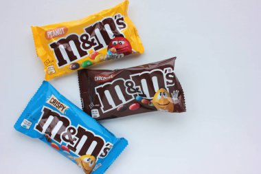 Kyiv - 12 Ocak 2021: Mars Inc. 'in beyaz arka planda yaptığı M & M' nin sütlü çikolata şekerlerinin yakın çekimi