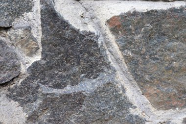 Taş duvar soyut arkaplanının yakın çekimi. Doğal doku.