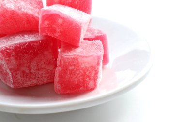 Beyaz masa arkaplanında şeker tozu olan kırmızı Türk lezzetleri. Doğulu tatlı tatlı tatlı rahat locum. Üst görünüm, alanı kopyala