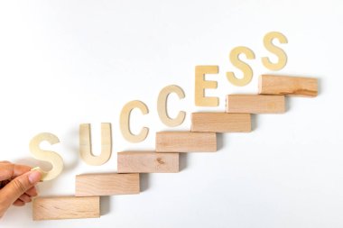 Merdivenler olarak ahşap blokları dizmeye odaklan. Büyüme süreci için iş konsepti. Kariyer artışının sembolü olan merdivenler ya da iş başarısı. Kelime SUCCESS yazıldı.