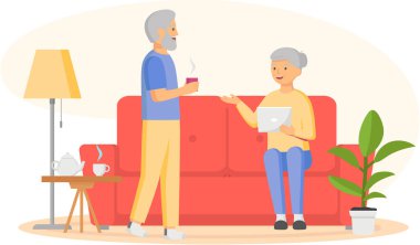 Kanepede oturan dizüstü bilgisayarı olan yaşlı kadın. Yaşlı adam ve kadın internette bilgisayar sörfü yapıyor