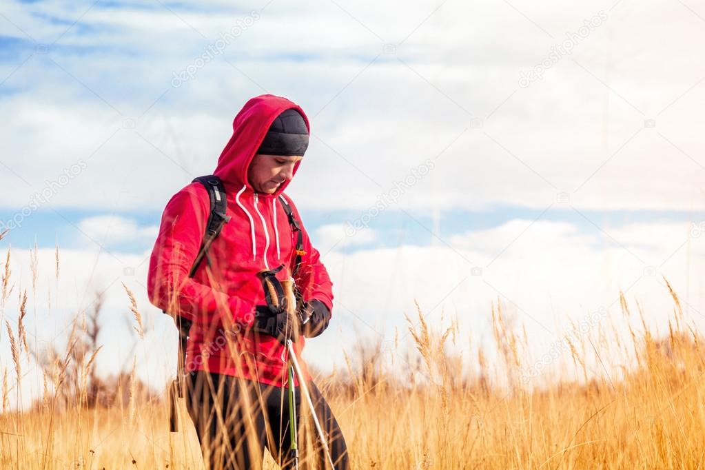 Portrait of hiker man standing in a scenic field landscape