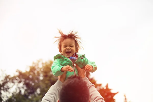 Fadern lyfta upp glad son i luften — Stockfoto