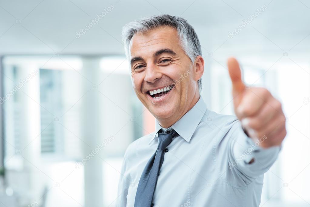 Cheerful businessman thumbs up