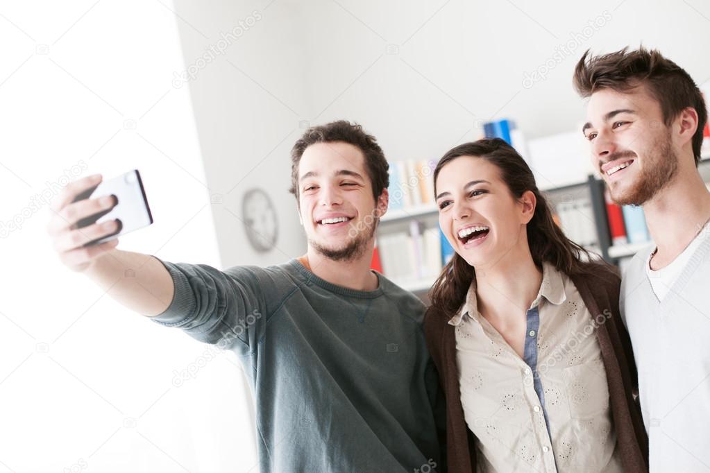Teenagers taking selfies with a mobile phone