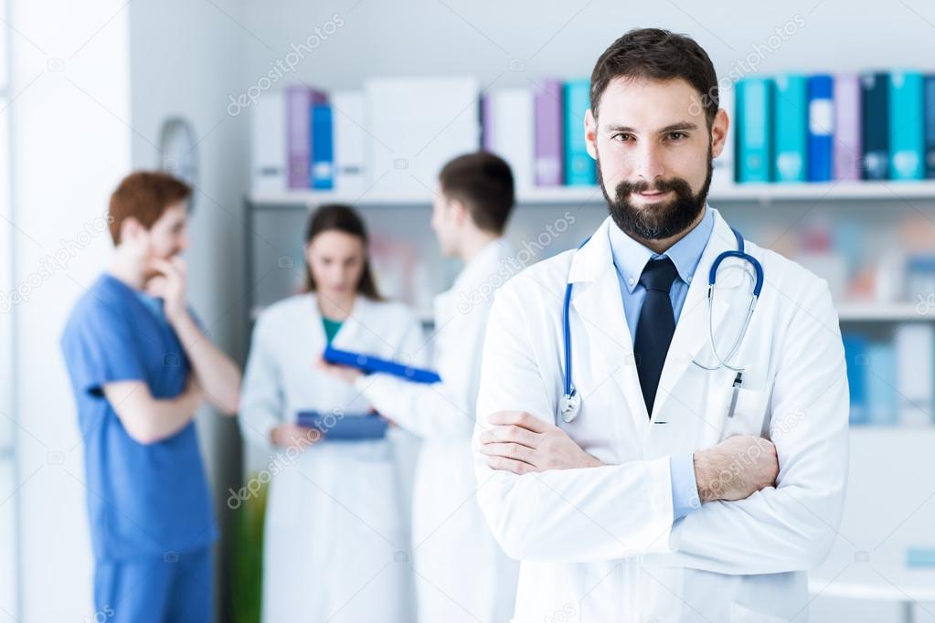 Confident doctor posing in the office