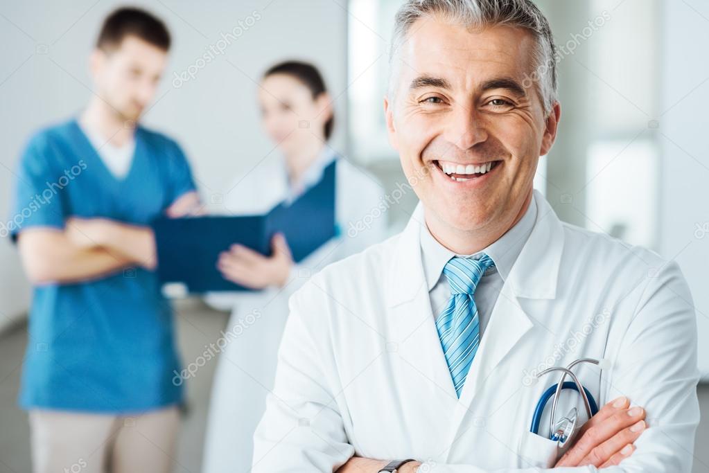 Confident doctor at hospital posing