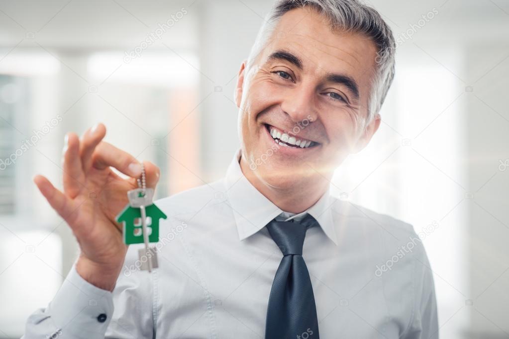 Real estate agent holding house keys