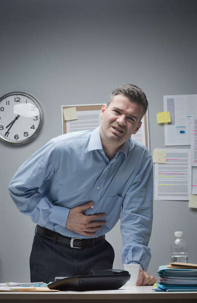 Stressed businessman with stomachache