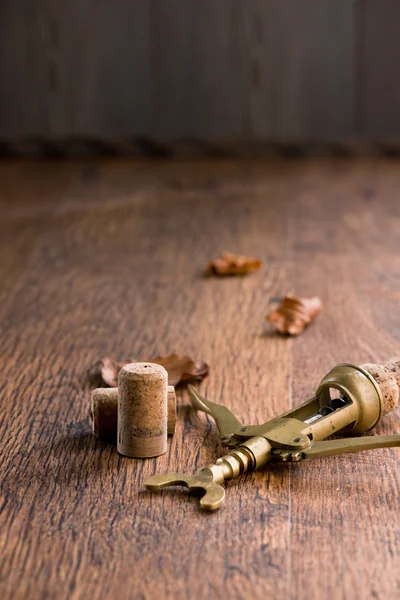 Old corkscrew on wooden table — Stock Photo, Image