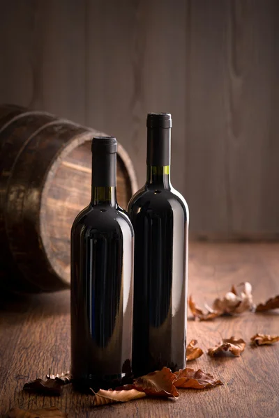 Wine bottles with fallen leaves — Stock Photo, Image