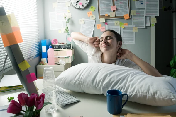 Businesswoman waking up in office — Stock Photo, Image