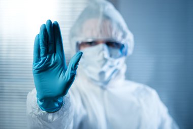 Kadın bilim adamı bu durumda koruyucu hazmat uygun el kaldırdı