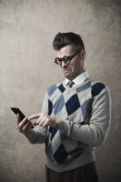 Funny guy having troubles with his smartphone — Stock Photo, Image