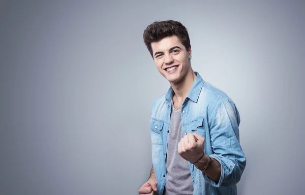 Cara sorrindo e mostrando punhos — Fotografia de Stock