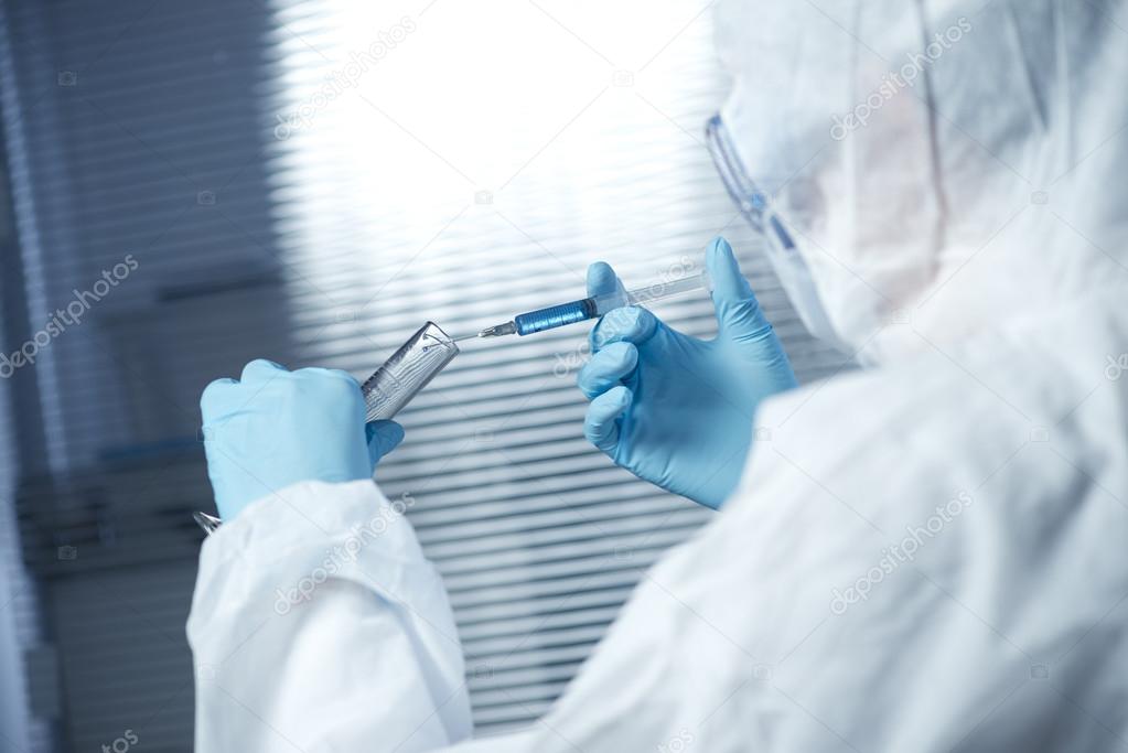 Researcher preparing a syringe for injection